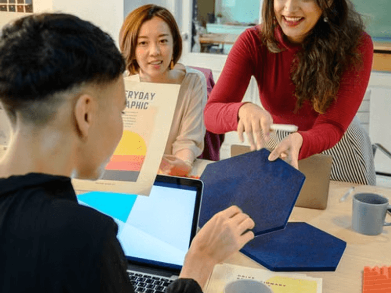 Creative startup team planning custom T-shirts and company apparel for business branding.